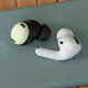 A single Pixel Buds Pro earbud next to a single AirPods Pro earbud.